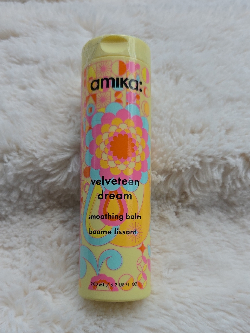 amika velveteen dream smoothing balm - yellow tube with multicolor floral print